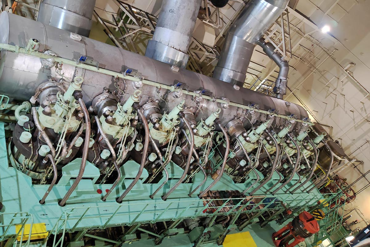 Offshore mechanical engineer performing marine engine overhaul inside ship engine room